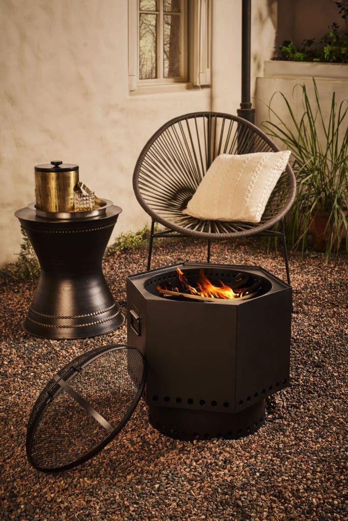 Bask under the warmth of this elegant firepit and lantern collection