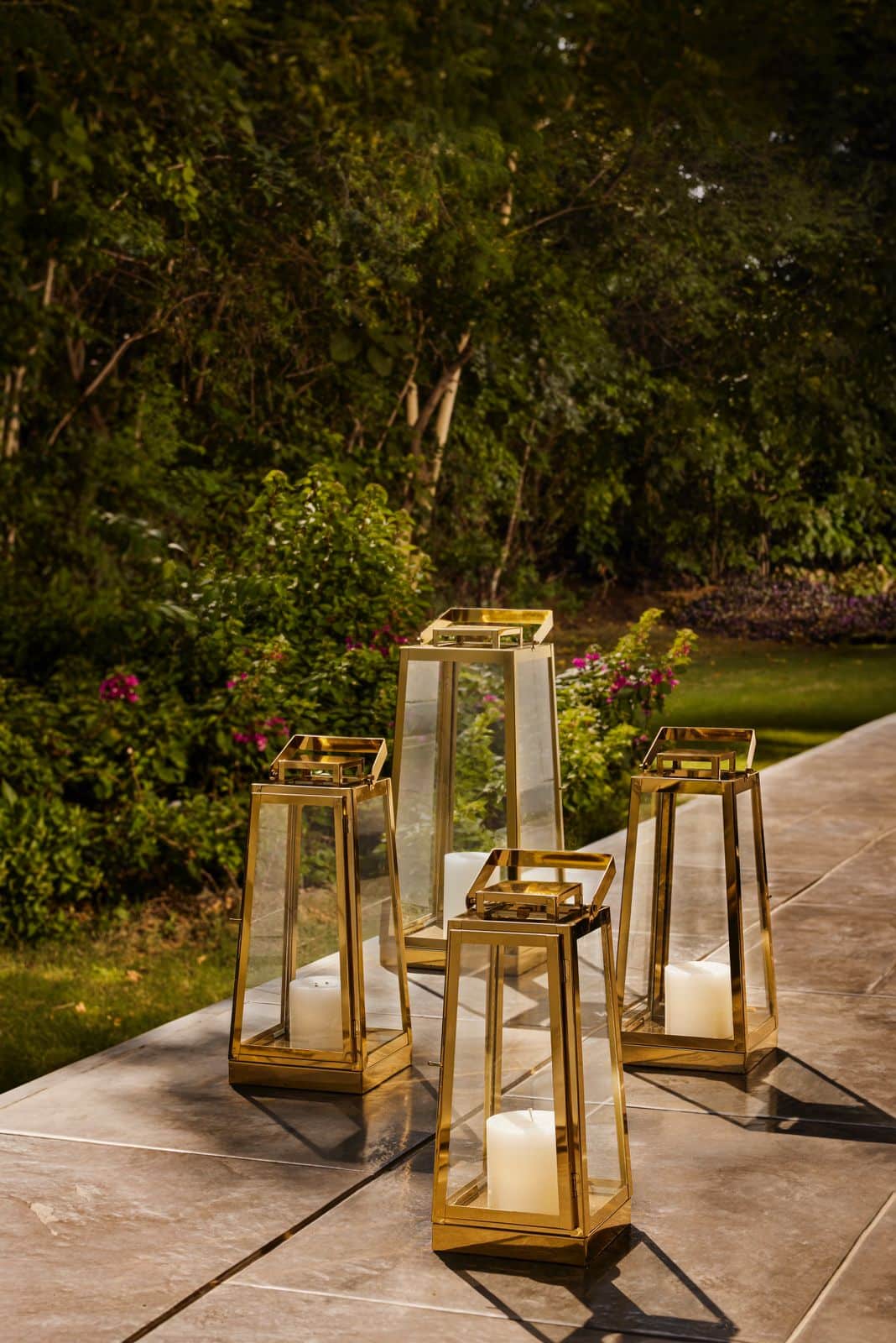 Bask under the warmth of this elegant firepit and lantern collection