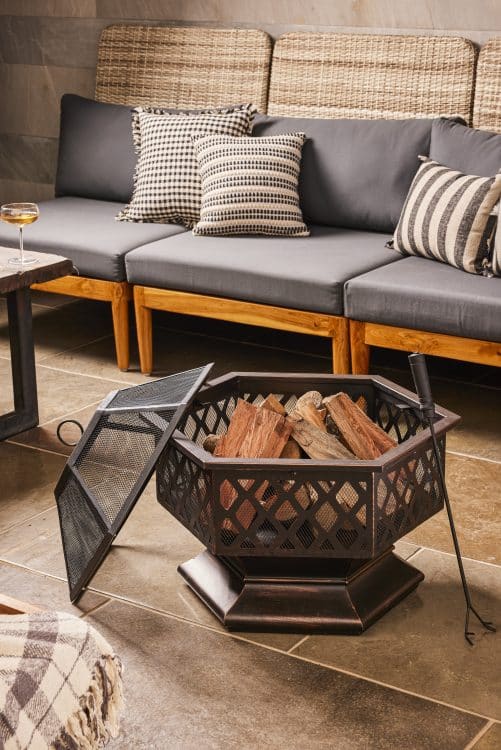 Bask under the warmth of this elegant firepit and lantern collection